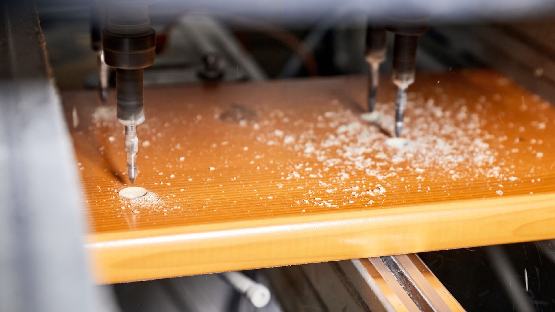 Holes are drilled into the wood of the beer table set.