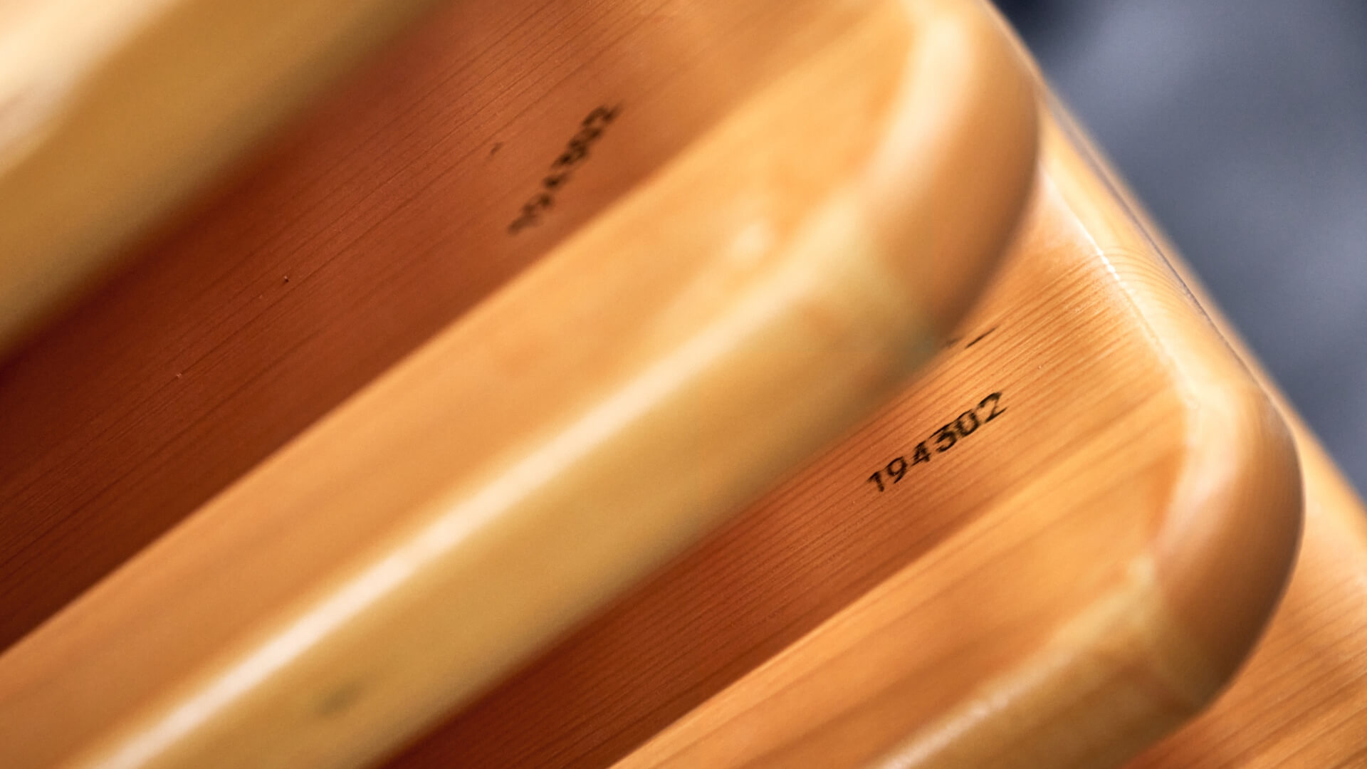 Several wooden boards in pine are stacked on top of each other.