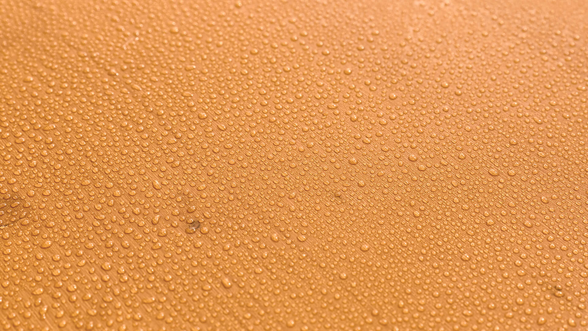 Beer garden table sets with water drops on the surface of the wood. The UV glaze protects the table top from deformation and discoloration. The set is therefore weather resistant and flame retardant.