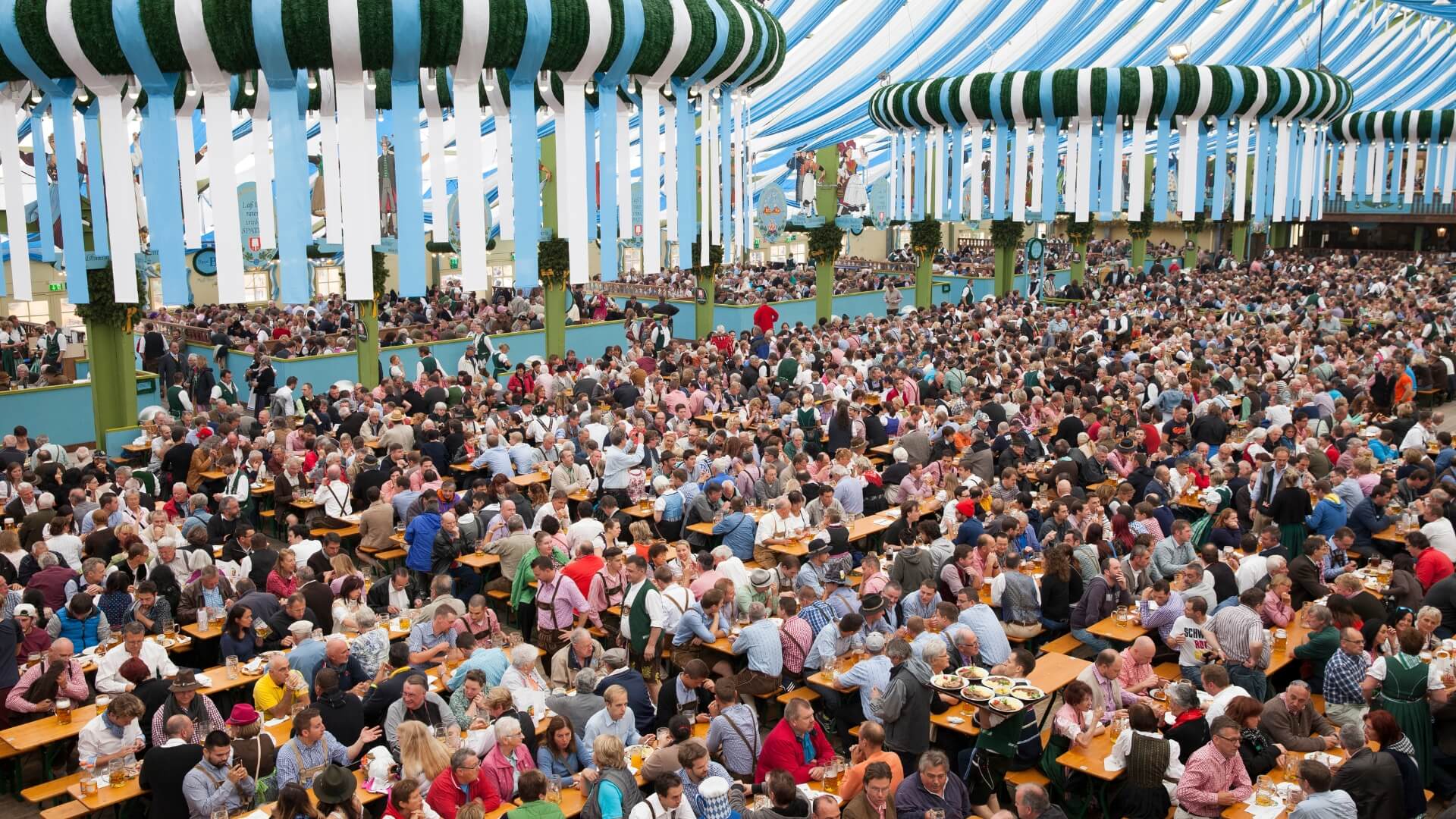 At Oktoberfest, people sit on the beer garden table sets with leg room.