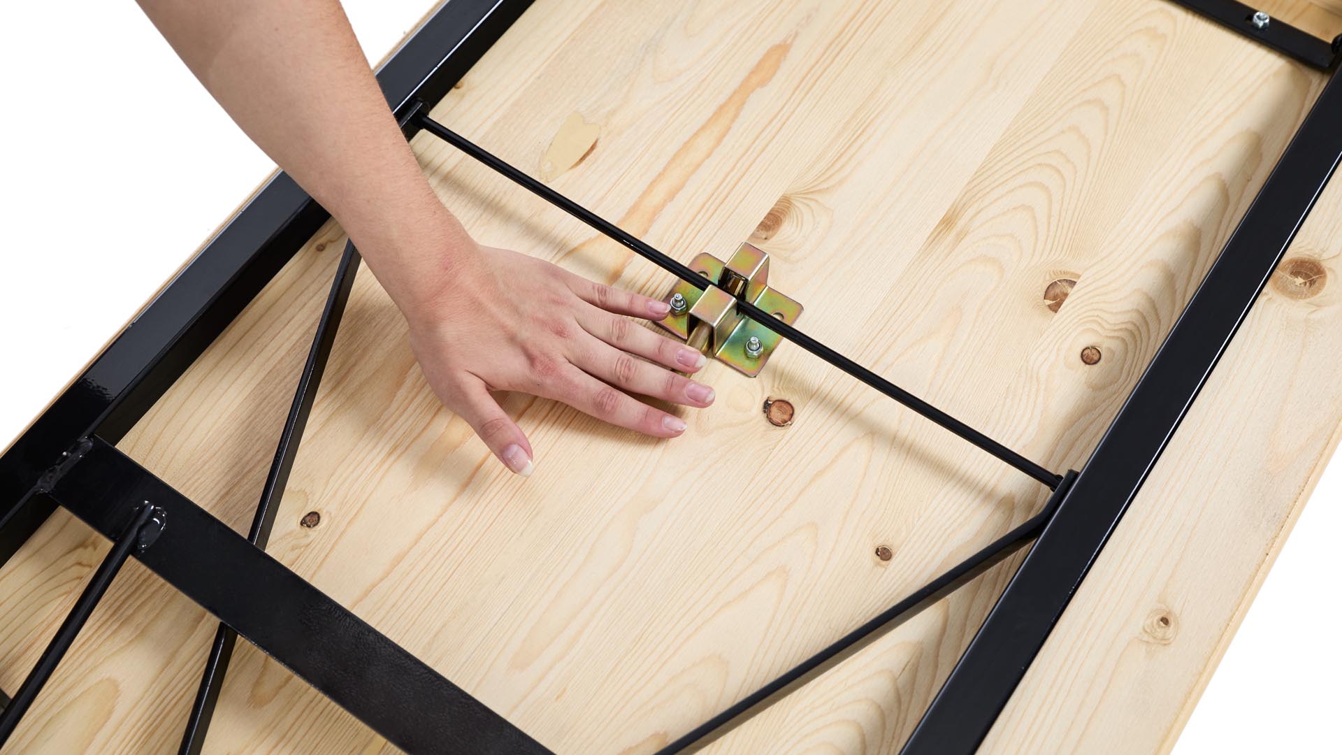 One hand pushes down the lever of the folding furniture lock to assemble the poseur table "200x60".