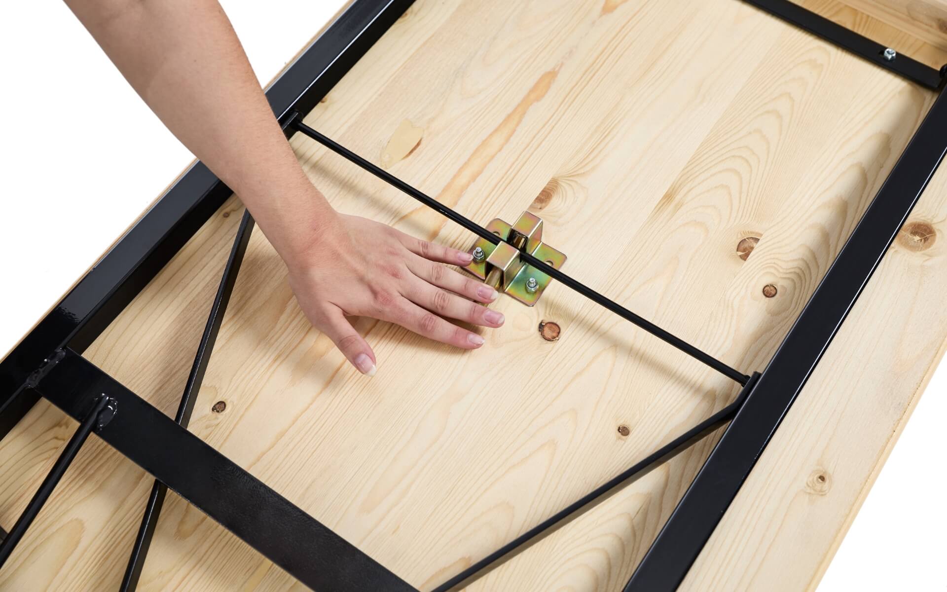One hand pushes down the lever of the folding furniture lock to assemble the poseur table "200x60".