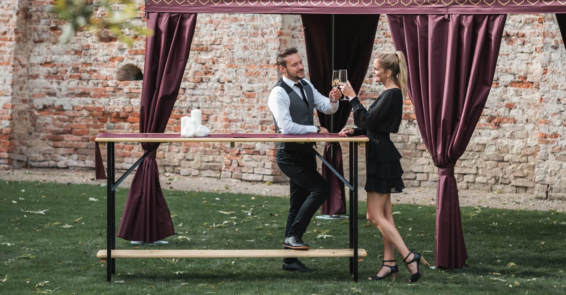 Two people standing at poseur table with an aperitif