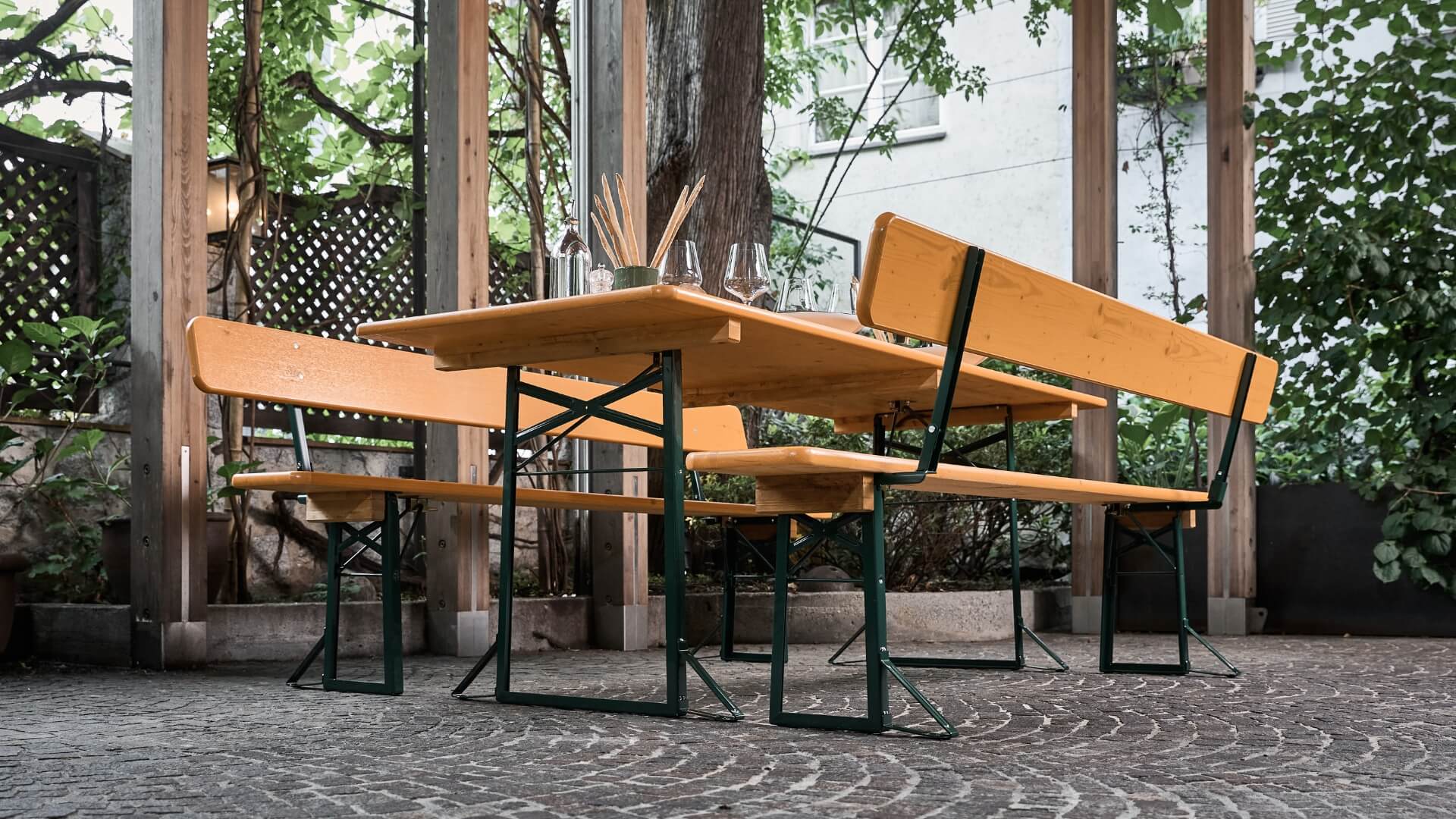 The wide beer garden table set was placed and decorated in the outdoor area of a restaurant.