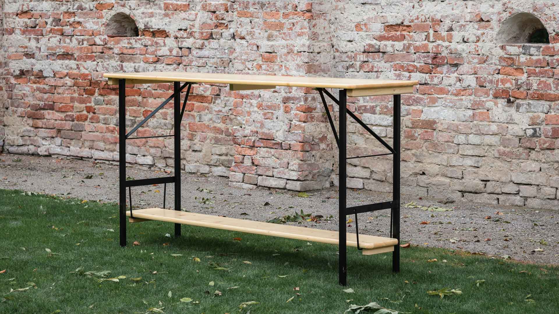 Poseur table 200x60 cm in natural color has a footboard and black frame