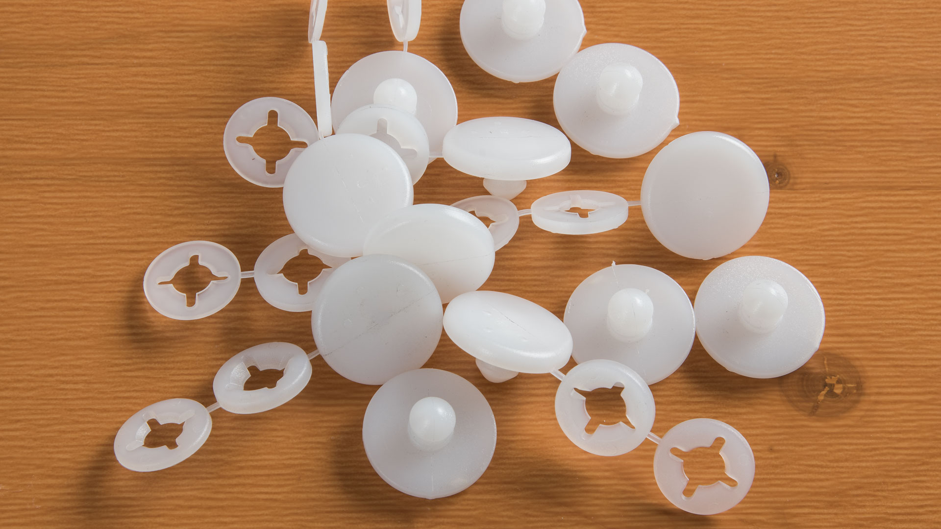 Some white plastic gliders lie on a table
