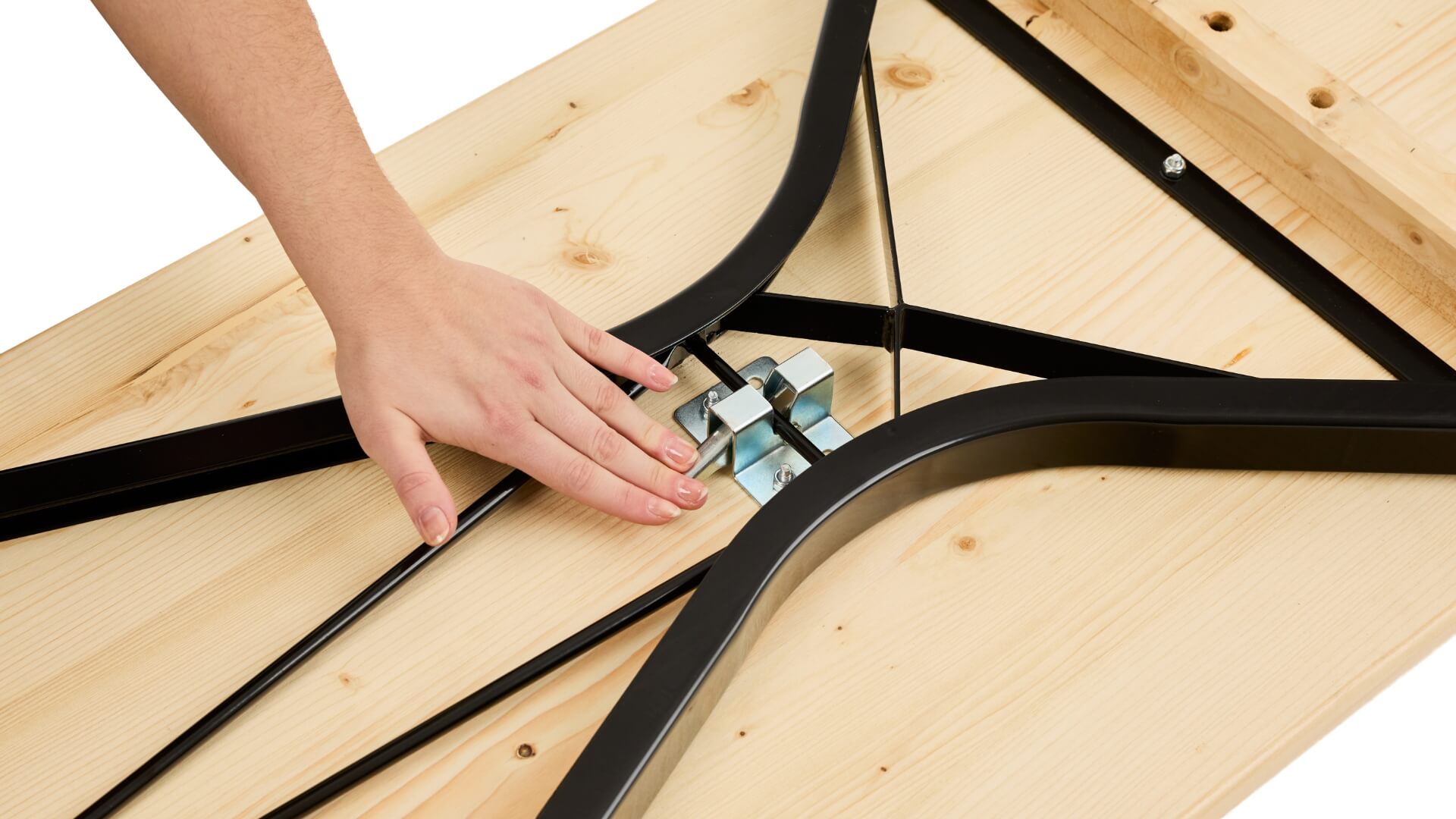 A hand pushes down the lever of the folding furniture lock to assemble the beer garden table set with legroom.