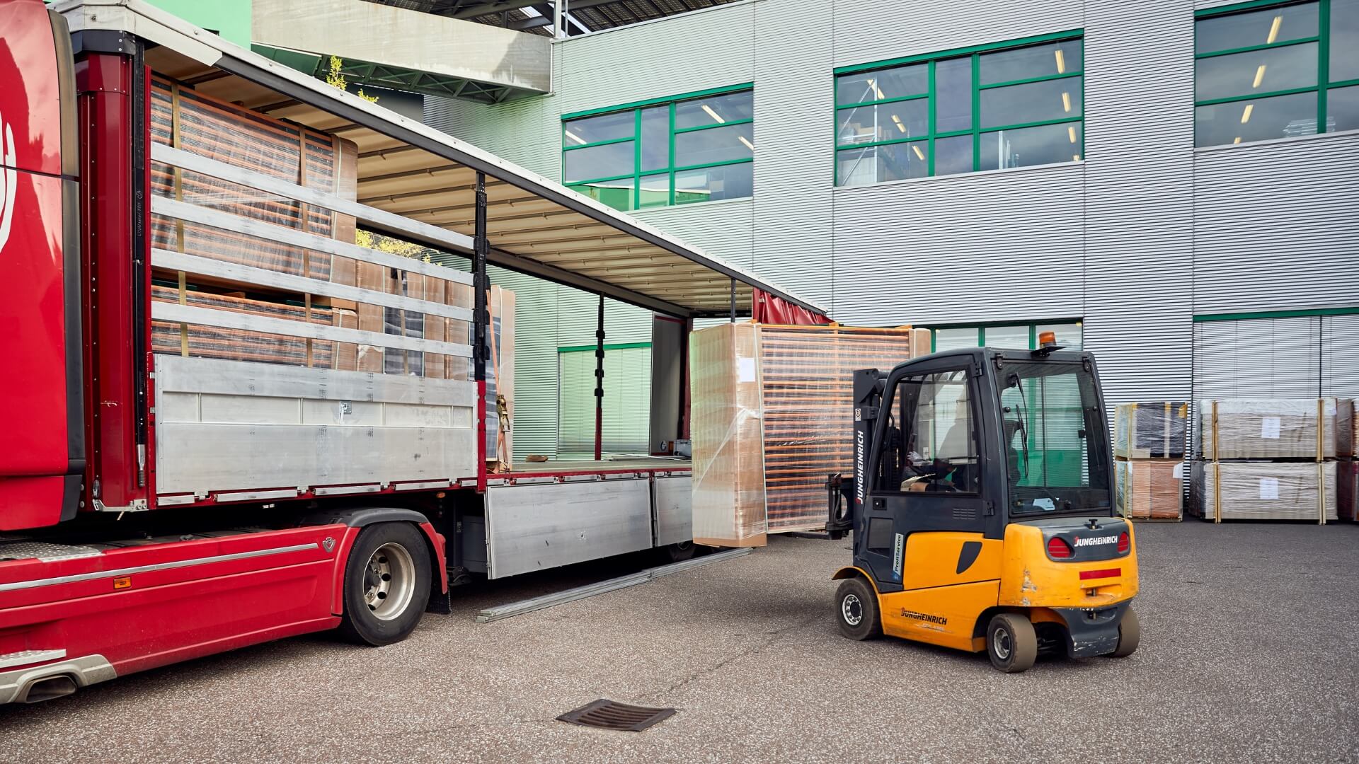 The packaged beer table sets are packed into a truck using a forklift.