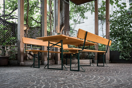 The wide beer garden table set was placed and decorated in the outdoor area of a restaurant.