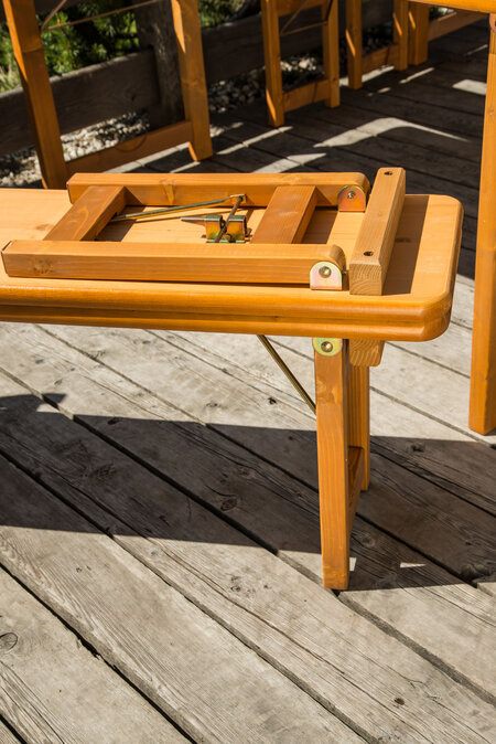 A folded beer bench from the Rustica design set is placed on top of an upright Rustica bench.