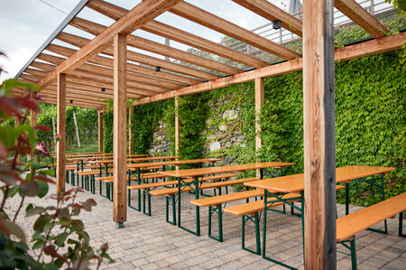 Classic beer garden table sets were set up on the terrace of Guggerhof.