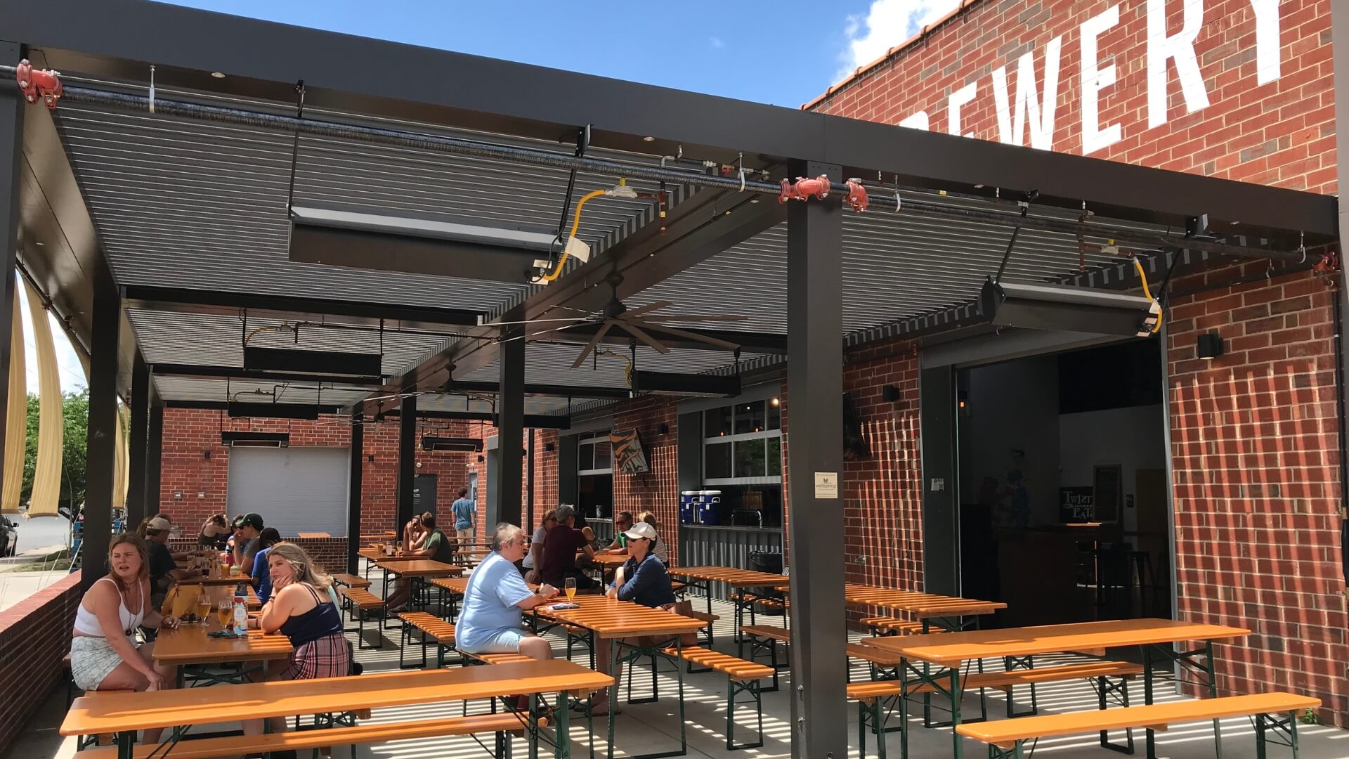 In Charlotte, classic beer garden table sets are on the patio at Wooden Robot Brewery.