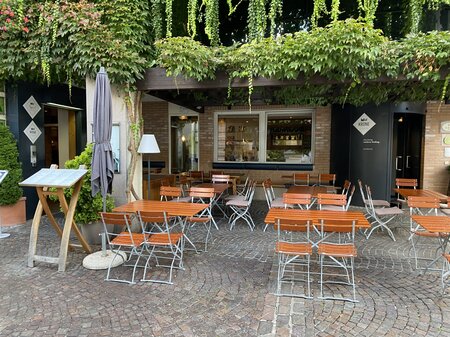 Square beer garden furniture is set up on the terrace of Hotel Krone.