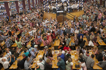 Many tables and benches of beer garden table sets with legroom at full Oktoberfest.