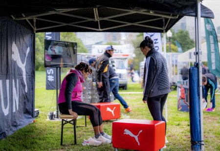 At the 10k Puma Marathon for Women in Boston, women sat on the small beer bench to try on shoes.